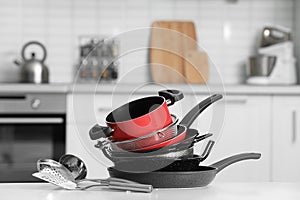 Set of clean cookware and utensils in kitchen photo