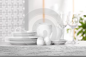 Set of clean dishware, focus on empty stone table