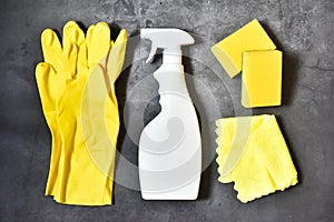 Set of cleaning supplies on a gray concrete background