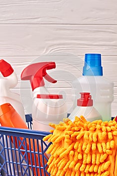 Set of cleaning supplies on wooden background.