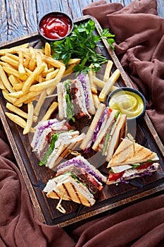 Set of club sandwiches on a serving wooden board