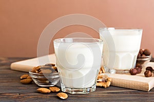 Set or collection of various vegan milk almond, cashew, on table background. Vegan plant based milk and ingredients, top