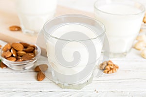 Set or collection of various vegan milk almond, cashew, on table background. Vegan plant based milk and ingredients, top