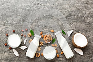 Set or collection of various vegan milk almond, coconut, cashew, on table background. Vegan plant based milk and