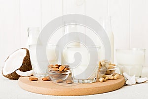 Set or collection of various vegan milk almond, coconut, cashew, on table background. Vegan plant based milk and