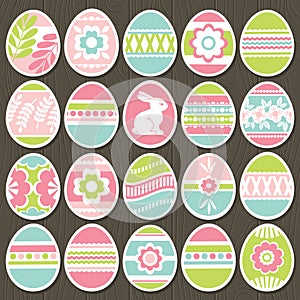 Set of color easter eggs over brown wooden background. Holiday Easter Eggs decorated with flowers, rabbit, leafs. Easter holidays