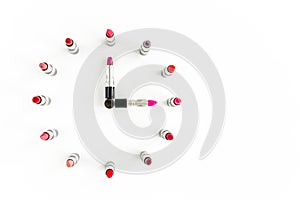Set of color lipsticks in the form of hours on white background. Professional decorative cosmetics, pomade. beauty