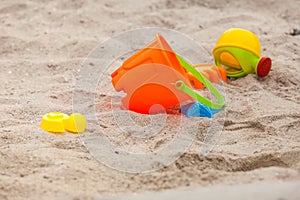 Set of color plastic toys on a sand