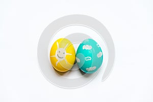 A set of colored Easter eggs painted like smiling sun and blue sky