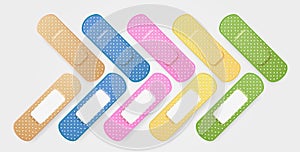 Set of colored medical plasters. Realistic oblong plaster in blue, yellow, pink, green color. Adhesive patch. First aid