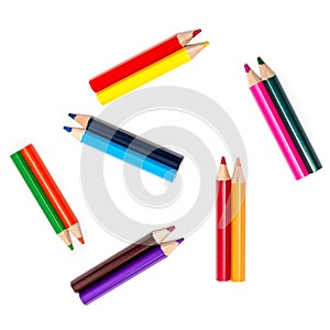 A set of colored pencils for children`s creativity and drawing lies in pairs, isolated