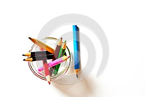 Set of colored pencils for creativity and drawing drawn up in a glass jar and isolated on a white background of a blank