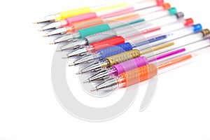 A set colored pens on a white background