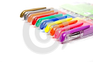 A set colored pens on a white background