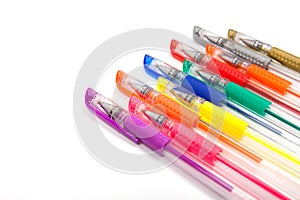 A set colored pens on a white background