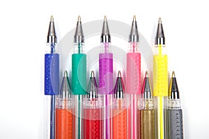A set colored pens on a white background