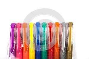 A set colored pens on a white background