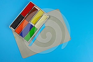Set of colored plasticine on a blue background, the concept of children's creativity, child development