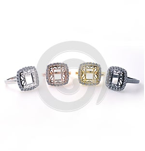 Set of colored rings with inlaid precious stones. Chromed metal rings on a neutral background