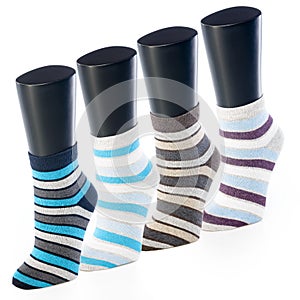 Set of colored socks in strip on mannequin for sport on white background