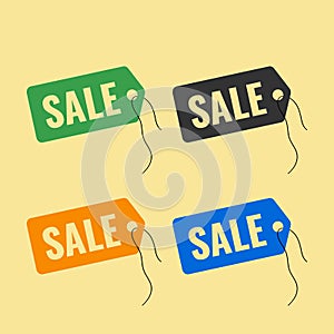 Set of colored tags on a thread with the text sale