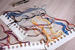 Set of colored threads for embroidery on the table