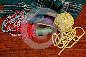 A set of colored threads and woolen cloth on the table