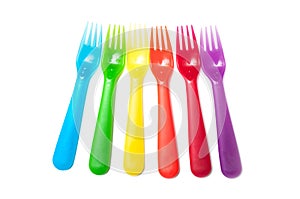 colorful baby plastic forks on white background
