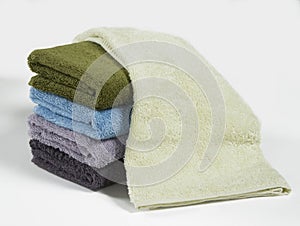 Set of colorful folded towels, isolated on white background