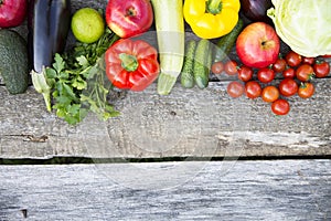 Set of colorful fruits and vegetables on dark wooden background.