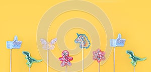 Set of colorful lollipops on yellow background. beautiful lollipops in the shape of dinosaur, unicorn, flower, and