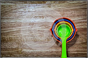 Set of Colorful Measuring Spoon on a Wooden Background