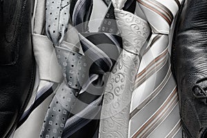 Set of colorful men`s ties on dark background.