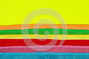 Set of colorful microfiber cleaning cloths on yellow background. Cleaning cloth for different purposes