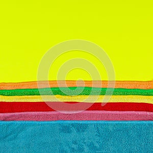 Set of colorful microfiber cleaning cloths on yellow background. Cleaning cloth for different purposes