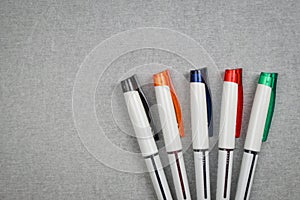 Set of colorful pen on gray cement texture.