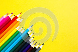 Set of colorful pencils on a yellow background. Copyspace, frame. Back to school, artist, drawing lessons. Stationery for