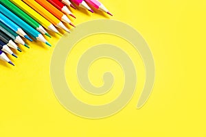 Set of colorful pencils on a yellow background. Copyspace, frame. Back to school, artist, drawing lessons. Stationery for