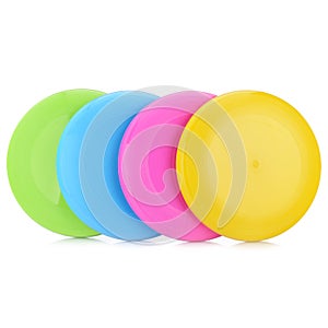 A set of colorful plastic frisbees for outdoor play. Children's active games. Lots of colored frisbees isolated on a