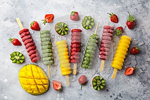 Set of colorful popsicles with fresh fruits and berries