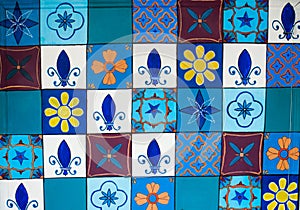 Set of colorful small tiles on a wall of a building.