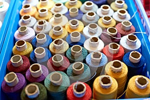 Set of colorful spools of thread.