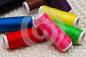 Set of colorful spools of thread close up