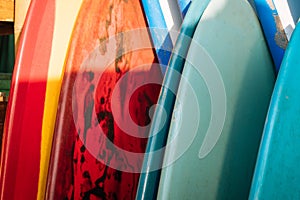 Set of colorful surfboard for rent on the beach. Multicolored surf boards different sizes and colors surfing boards on