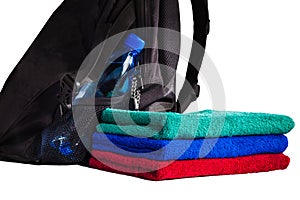 Set of colorful towels and backpack with bottle of water