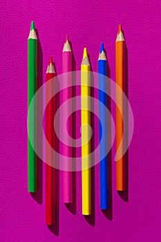 Set of colorful wooden pencils on  pink background. Minimal style. Top view. Flat lay. Back to school concept