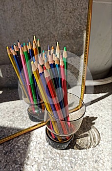 Set of colourful pencils in front of a mirror. Many colors