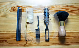 SET OF COMBS, AND BRUSHES PLACED ON WOOD