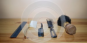 SET OF COMBS, AND BRUSHES PLACED ON WOOD