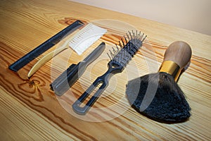 SET OF COMBS, AND BRUSHES PLACED ON WOOD